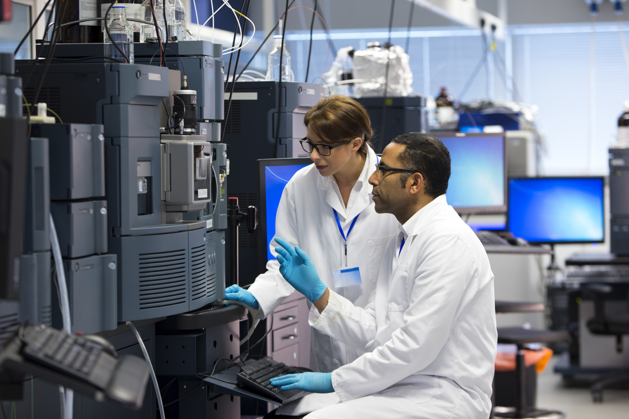 People Working with Specialist Scientific Equipment for Measuring Chemicals.